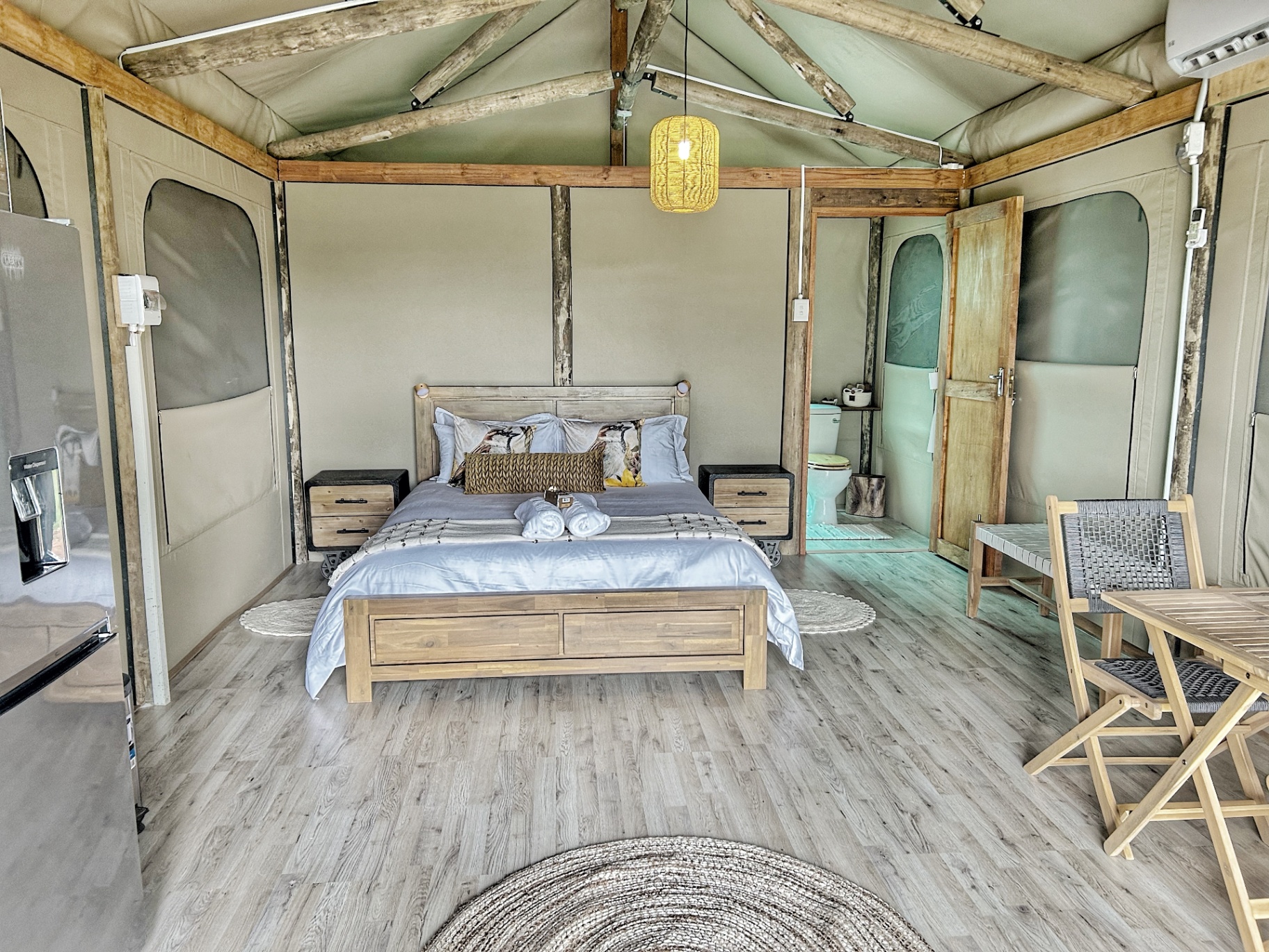 Interior of a Wildeolyf safari tent with lantern light